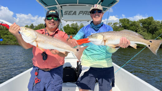 The Captains holding two large Redfish